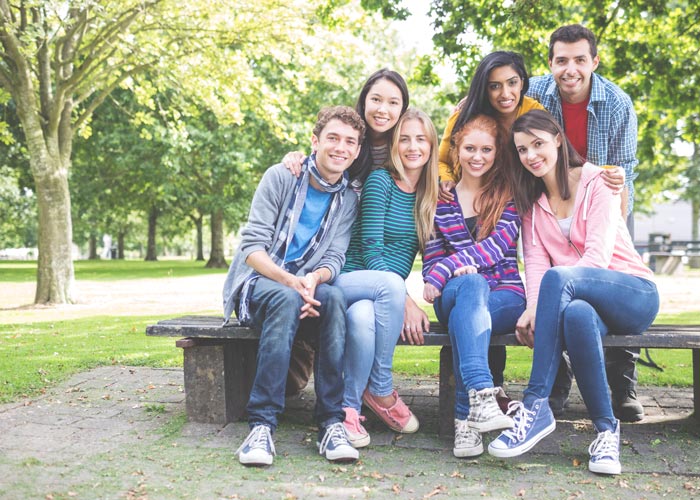 Group of teenagers on a park bench